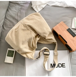 Detail of beige corduroy tote bag with adjustable strap on a minimalist lifestyle setting