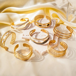 Golden stainless steel cuff bracelets with marble inlay and black enamel finish