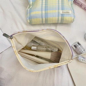 Top view of colorful plaid canvas cosmetic bags with metal zippers and large capacity