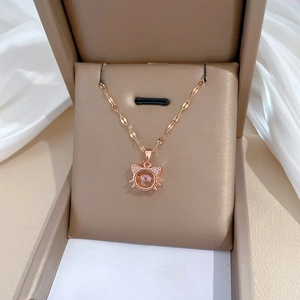 Detail of rose gold cat pendant with shimmering crystals and moving center stone