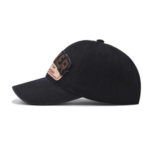 Detailed side view of black vintage baseball cap with ER letter embroidery patch