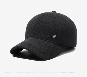 Detail view of men's winter baseball cap with dark gray knit texture and side shield logo