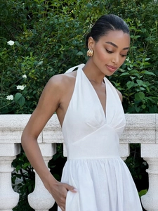 Detail of white halter V-neck maxi dress with cotton texture and cinched waist design