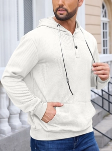 Detail of white textured wave knit hoodie featuring metal button neck and drawstring hood