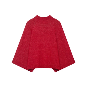 Detail of red mock neck knit sweater showing high-quality wool texture and wide cape sleeves