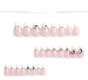 Detail view of 24pcs long coffin press-on nails with pink French tips and crystal charms