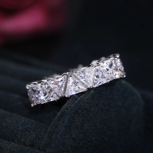 Macro shot of silver ring with full triangle-cut cubic zirconia in eternity band style