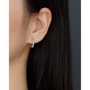 Close-up of S925 silver U-shaped earring with cubic zirconia on model's ear