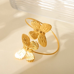 Polished gold butterfly open cuff bracelet in stainless steel with textured detail