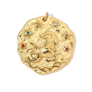 Macro detail of 18K gold Capricorn zodiac coin pendant with colorful zircon stones
