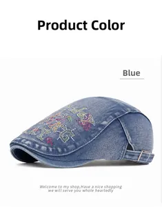 Detailed macro view of vintage blue denim beret with colorful letter embroidery and metal buckle