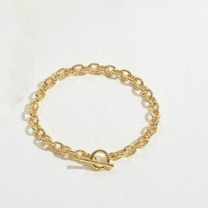 Close-up of gold-plated water ripple chain with detailed OT toggle clasp and hammered rings