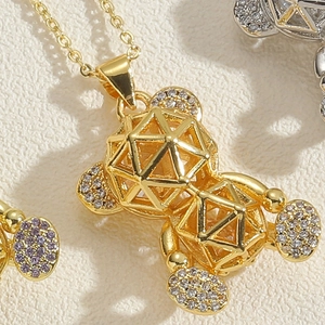 Macro shot of 14K gold plated hollow teddy bear pendant with sparkling zircon details