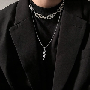 Hip-hop punk silver flame and lightning pendant necklaces layered on model