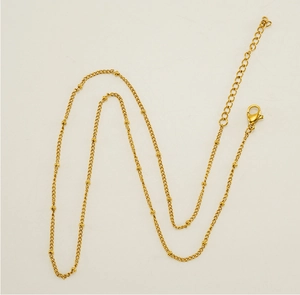 Close-up of golden 304 stainless steel bead chain with lobster clasp and extender