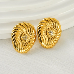 Close-up of 18K gold stainless steel earrings with spiral texture and center zircon cluster