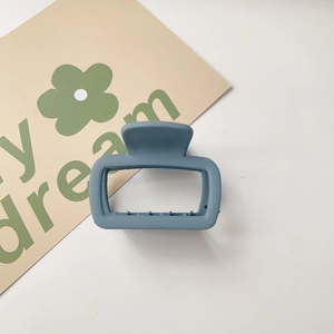 Close-up of matte Morandi blue square hair claw clip with non-slip teeth on white background