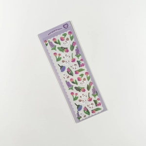 Close-up of holographic cat and tulip stickers for scrapbooking and decoration