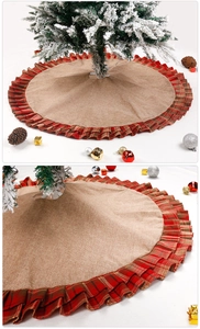 Close-up of linen Christmas tree skirt with red plaid pleated edges and burlap texture