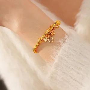 Elegant 24k gold-plated twisted chain bracelet with oval zircon and flower charms