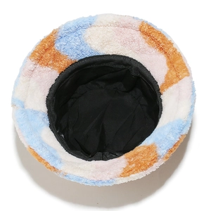 Detail view of colorful faux fur bucket hat showing inner black lining and soft texture
