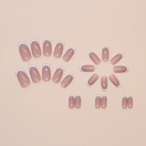 French manicure press-on nails in nude pink with white tips and silver glitter accents