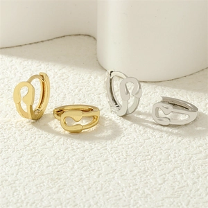 Detail of safety pin hoop earrings in 18K gold and silver plating with zircon micro-pave