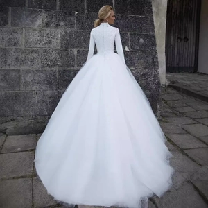Elegant white lace long sleeve wedding dress with high neck and voluminous tulle train