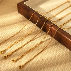 Five styles of 18K gold plated stainless steel chains displayed on dark wooden tray