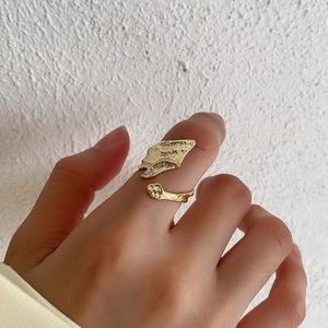 Irregular lava texture open ring in gold finish worn on finger for a stylish metal look