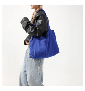 Detail of blue corduroy tote bag showing ribbed texture and large capacity for women
