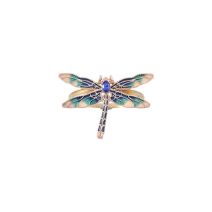 Golden dragonfly napkin ring with blue green enamel and inlaid gemstone on white background