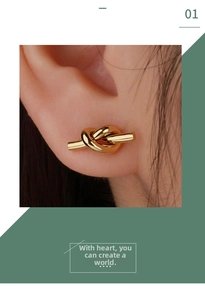 Macro shot of minimalist gold knotted stud earring on ear with high polish finish