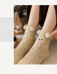 Close-up of thick beige coral fleece socks featuring 3D sheep ears and cute embroidery