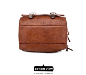 Detail view of brown faux leather bag with litchi texture and silver metal fasteners