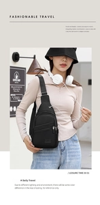 Detail of black nylon sling bag with multiple zippers and earphone port in street setting