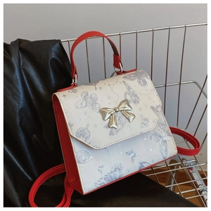 Contrast color butterfly print ladies backpack with silver bow buckle and red straps