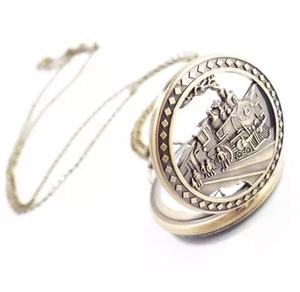 Detail view of vintage bronze pocket watch hollow cover with steam train motif