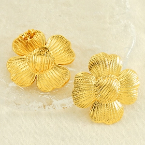 Elegant 18k gold-plated sunflower petal stud earrings on textured glass backdrop