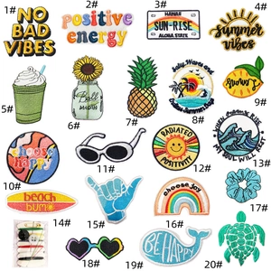 Detailed grid of 20 unique embroidered travel patches featuring mountain and sun patterns