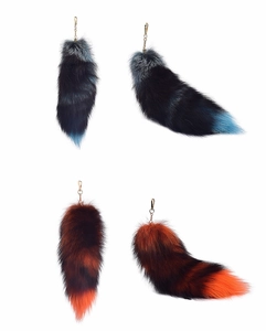 Close-up of fluffy faux fur fox tail keychains with golden lobster clasps in various colors