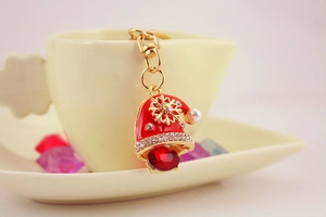 Detailed view of red Christmas hat keychain with rhinestones and pearl accents