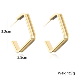 Detailed view of geometric gold earrings showing dimensions 3.2cm by 2.5cm and 7g weight
