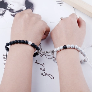 Detail showing magnetic heart clasp attracting natural stone beaded couple bracelets