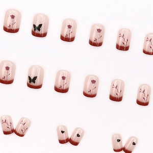 Press-on nail set featuring nude pink base with burgundy gradient and vintage floral prints