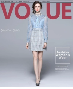 Detail of light blue lace sleeve and grey tweed patchwork on an elegant mini dress