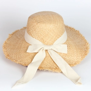 Wide-brim raffia sun hat with bow tie and frayed edges for summer beach vacation