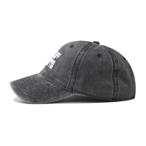 Detail view of side white embroidery on washed dark grey vintage cotton baseball cap