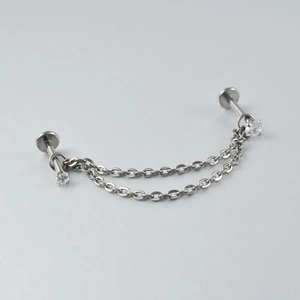 Detailed view of G23 titanium nose stud with double silver chains and zircon stone