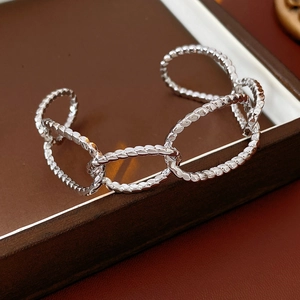 Detail of silver hammered texture on irregular oval link bracelet with high-quality finish